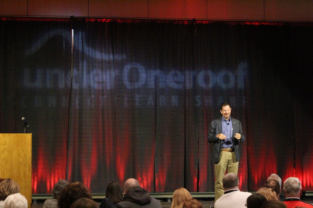 UnderOneRoof conference speaker addressing audience